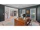 Spacious home office with a large desk, two chairs, and natural light at 19746 Valiant Way, Cornelius, NC 28031