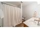 Bright bathroom featuring a shower with curtain, toilet, and a double sink vanity with white countertops at 211 Tyndale Ct, Waxhaw, NC 28173