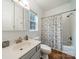 Bathroom with white tiling, shower-tub combo, wood flooring, and a single window at 211 Tyndale Ct, Waxhaw, NC 28173