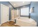 Bathroom features a soaking tub with shower and a glass enclosed shower at 211 Tyndale Ct, Waxhaw, NC 28173