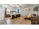 Main bedroom with a tray ceiling, wood flooring, a lounger, and natural light at 211 Tyndale Ct, Waxhaw, NC 28173
