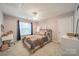 Bedroom features a ceiling fan, and large window with a desk area at 211 Tyndale Ct, Waxhaw, NC 28173