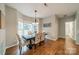 A dining room featuring a table, chairs, hardwood flooring, chandelier, and a bay window at 211 Tyndale Ct, Waxhaw, NC 28173