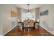 A dining room featuring a wooden table, six chairs, hardwood flooring, and a bay window at 211 Tyndale Ct, Waxhaw, NC 28173