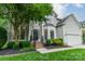 Beautifully landscaped front yard with a two-story home, black accents, and a well-maintained lawn at 211 Tyndale Ct, Waxhaw, NC 28173