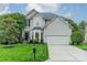 Charming two-story home boasts a manicured lawn, mature trees, and a classic architectural design at 211 Tyndale Ct, Waxhaw, NC 28173