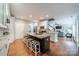 Open kitchen area with a center island, stool seating, and view to the living room at 211 Tyndale Ct, Waxhaw, NC 28173