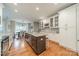 Open-concept kitchen with an island, granite countertops, and adjacent dining area at 211 Tyndale Ct, Waxhaw, NC 28173
