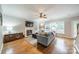Inviting living room featuring a fireplace, ceiling fan, hardwood floors and natural light at 211 Tyndale Ct, Waxhaw, NC 28173