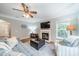 Cozy living room with hardwood floors, fireplace, modern decor and a large window at 211 Tyndale Ct, Waxhaw, NC 28173