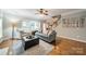 Hardwood floors and staircase accent this living room with natural light and modern decor at 211 Tyndale Ct, Waxhaw, NC 28173