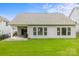 Rear exterior view of home showcasing a covered patio and large windows overlooking the backyard at 219 Broadleaf Dr, Denver, NC 28037