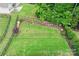 Spacious backyard with lush green grass, enhanced by a beautiful garden and a secure black fence at 219 Broadleaf Dr, Denver, NC 28037