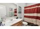 Bathroom featuring a single vanity with a mirror and a shower with a patterned curtain at 219 Broadleaf Dr, Denver, NC 28037