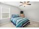 Bright bedroom with a striped bedspread, a window, and a ceiling fan at 219 Broadleaf Dr, Denver, NC 28037
