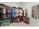 Walk-in closet with clothes hanging on rods, shelving, and space for storage containers at 219 Broadleaf Dr, Denver, NC 28037