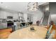 Open concept kitchen with island and dining table, modern light fixture at 219 Broadleaf Dr, Denver, NC 28037