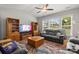Cozy living room with comfortable seating, a ceiling fan, and large windows offering natural light at 219 Broadleaf Dr, Denver, NC 28037