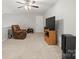 Bright living room with a ceiling fan, TV, and neutral carpeting at 219 Broadleaf Dr, Denver, NC 28037