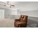 Relaxing living room featuring a comfortable recliner and neutral color palette at 219 Broadleaf Dr, Denver, NC 28037