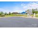 Community pool area featuring an entry gate, ample parking, and playground at 219 Broadleaf Dr, Denver, NC 28037