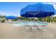 Resort-style pool area with lounge chairs and shaded umbrellas for relaxation and enjoyment at 219 Broadleaf Dr, Denver, NC 28037