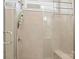 Shower features glass enclosure, tiled walls, a shower caddy, and a built-in bench at 219 Broadleaf Dr, Denver, NC 28037