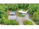 Aerial view of property with a Quonset hut, sheds, a gravel driveway, manicured yard, and wooded surroundings at 2289 Mccloud St, Denver, NC 28037