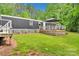 Backyard featuring a wooden deck with a shade canopy, and a well maintained lawn at 2289 Mccloud St, Denver, NC 28037