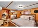 Comfortable bedroom with wood paneling, decorative hats, vanity, and large bed at 2289 Mccloud St, Denver, NC 28037
