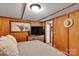 Well-lit bedroom with a bull picture, warm wood paneling, and cozy bed at 2289 Mccloud St, Denver, NC 28037