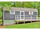 A view of the shed that has wooden deck, gray siding, and white trim, set on a grass lawn at 2289 Mccloud St, Denver, NC 28037