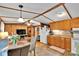 Open kitchen featuring wooden cabinets, dining area, white appliances, and tile flooring at 2289 Mccloud St, Denver, NC 28037