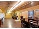 Spacious living room featuring wood walls, desk area, and dining table set, perfect for Gathering gatherings at 2289 Mccloud St, Denver, NC 28037