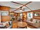 Cozy living room featuring wood paneled walls, a ceiling fan, and comfortable furnishings at 2289 Mccloud St, Denver, NC 28037