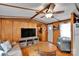 Inviting living room with wood paneled walls, a TV, and comfortable seating at 2289 Mccloud St, Denver, NC 28037
