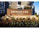 Street view of Hedgecliff Townes entrance sign surrounded by landscaping and townhome exteriors at 2440 Hedgecliff Rd, Kannapolis, NC 28025
