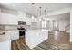 Open kitchen design featuring white cabinetry, stainless steel appliances, and a quartz countertop island at 2440 Hedgecliff Rd, Kannapolis, NC 28025