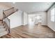 Open-concept living area boasts hardwood floors, staircase, and seamless flow to the kitchen at 2440 Hedgecliff Rd, Kannapolis, NC 28025
