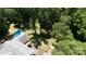 Aerial view of a landscaped home surrounded by mature trees with a private in-ground pool at 2605 Camelot Dr, Rock Hill, SC 29732