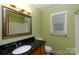 Bathroom features green walls, a single vanity, and a mirror at 2605 Camelot Dr, Rock Hill, SC 29732