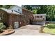 Rear exterior view showing a brick home with attached garage and deck above at 2605 Camelot Dr, Rock Hill, SC 29732