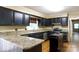 Well-lit kitchen with granite counters, black cabinetry, stainless steel appliances, and a view to the backyard at 2605 Camelot Dr, Rock Hill, SC 29732
