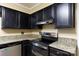Kitchen with black cabinetry, stainless steel oven and dishwasher, with granite countertops at 2605 Camelot Dr, Rock Hill, SC 29732