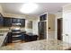 Spacious kitchen with stainless appliances, granite countertops, and black cabinetry with access to a separate room at 2605 Camelot Dr, Rock Hill, SC 29732