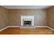 Bright living room with a brick fireplace, hardwood floors, and freshly painted walls at 2605 Camelot Dr, Rock Hill, SC 29732