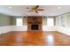 Spacious living area with a brick fireplace, built-in shelves, and a ceiling fan at 2605 Camelot Dr, Rock Hill, SC 29732