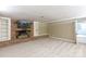 Cozy living room with brick fireplace, built-in shelving, and neutral carpeting at 2605 Camelot Dr, Rock Hill, SC 29732