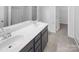 Bathroom featuring a double sink vanity, white cabinets, and a large mirror at 2618 Mt Holly Huntersville Rd, Charlotte, NC 28214