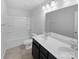 Bathroom with double sinks, tile flooring, and shower-tub combo at 2618 Mt Holly Huntersville Rd, Charlotte, NC 28214